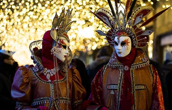 Costumed revelers gather for Venice Carnival