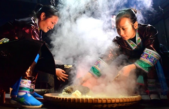 Women of Miao ethnic group make traditional festive drinking