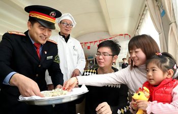 Attendants deliver free dumplings to passengers on train in E China