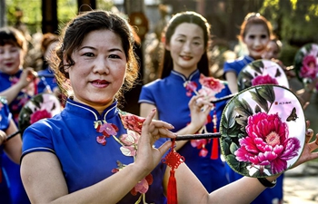 Women present cheongsam in NW China's Shaanxi