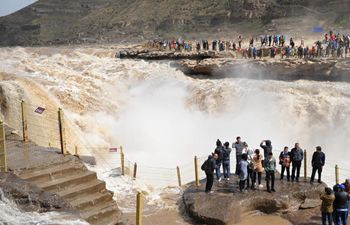 Tourists visit Hukou Waterfall of Yellow River