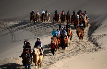 Tourists visit Mingsha Mountain, Crescent Spring scenic zone in Dunhuang