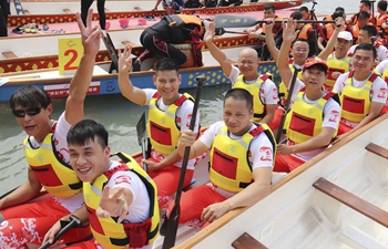 People take part in dragon boat match in Wenzhou, east China