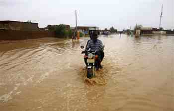 In pics: local citizens wade through rainwater in Khartoum, Sudan