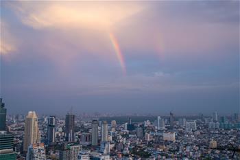 Rainbow appears in sky after rainfall in Bangkok, Thailand