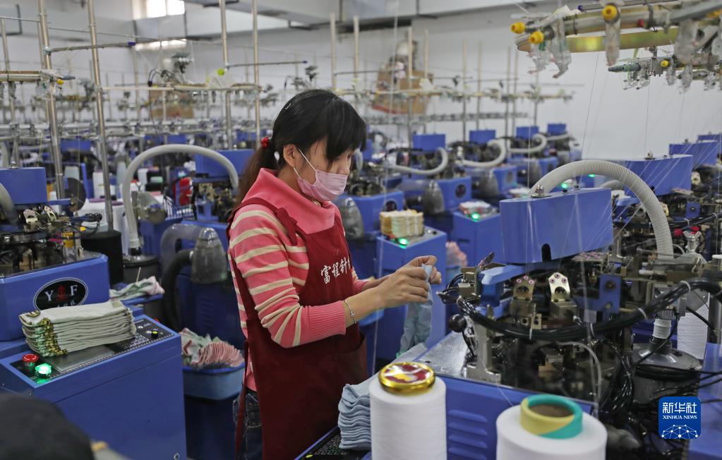 在小北河镇富程针织厂,工人在生产袜子(2020年1月7日摄.