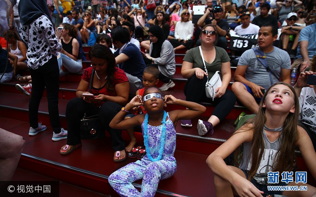 ***_***NEW YORK, USA - AUGUST 21: People gather to observe the total solar eclipse with solar eclipse glasses at the Times Square in New York City, United States on August 21, 2017. (Photo by Volkan Furuncu/Anadolu Agency/Getty Images)